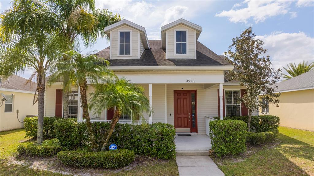 4978 Strand Street Kissimmee, FL 34758 - Photo 1 of 30 a front view of a house with garden