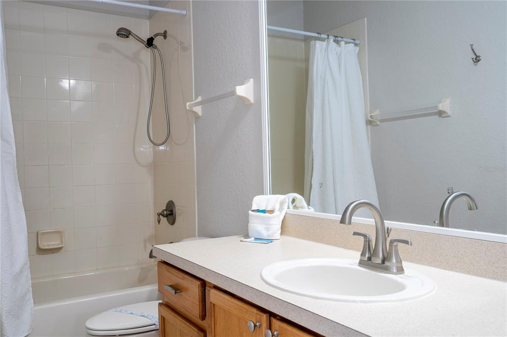 4978 Strand Street Kissimmee, FL 34758 - Photo 14 of 30 a bathroom with a sink toilet and shower