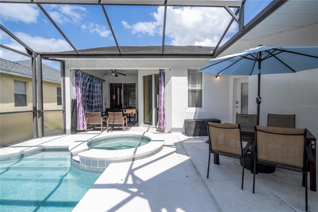 4978 Strand Street Kissimmee, FL 34758 - Photo 21 of 30 a view of a patio with a table and chairs under an umbrella