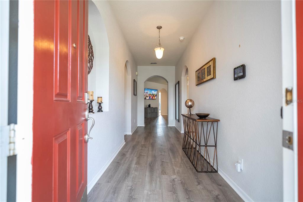 4978 Strand Street Kissimmee, FL 34758 - Photo 5 of 30 a view of a hallway with wooden floor and staircase