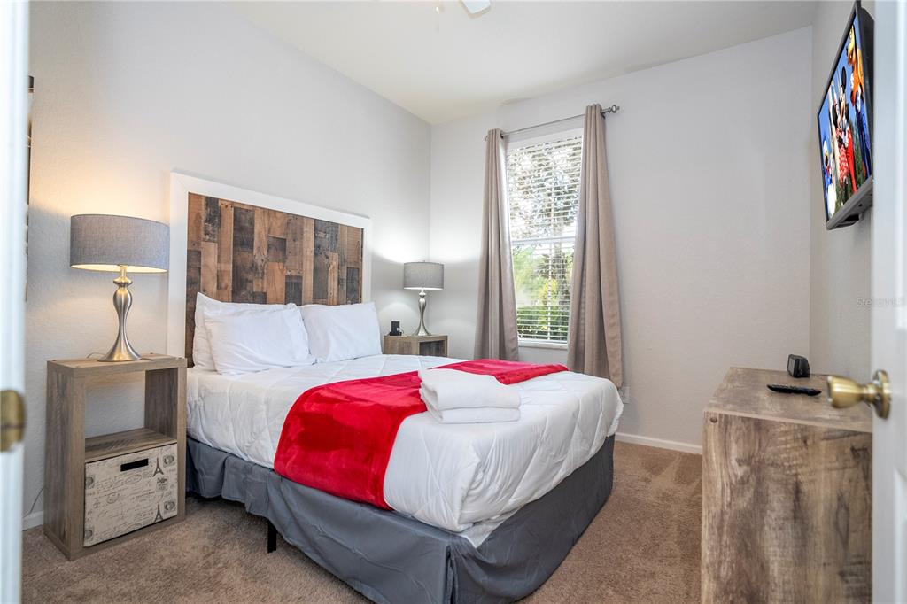 4978 Strand Street Kissimmee, FL 34758 - Photo 9 of 30 a bedroom with a bed and a lamp