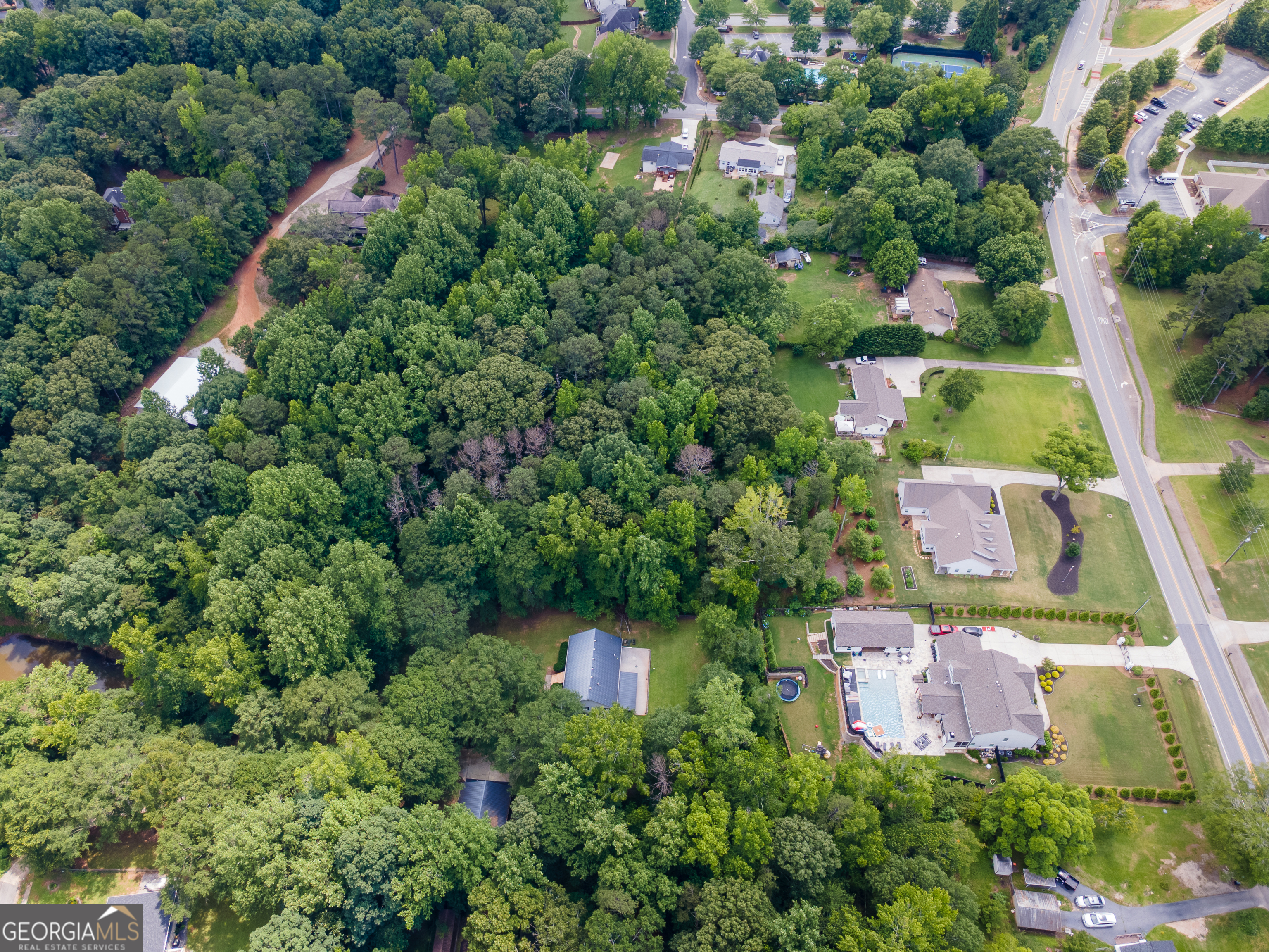 4017 South South Bogan Road Buford, GA 30519 - Photo 4 of 11 an aerial view of a house with a yard and lake view