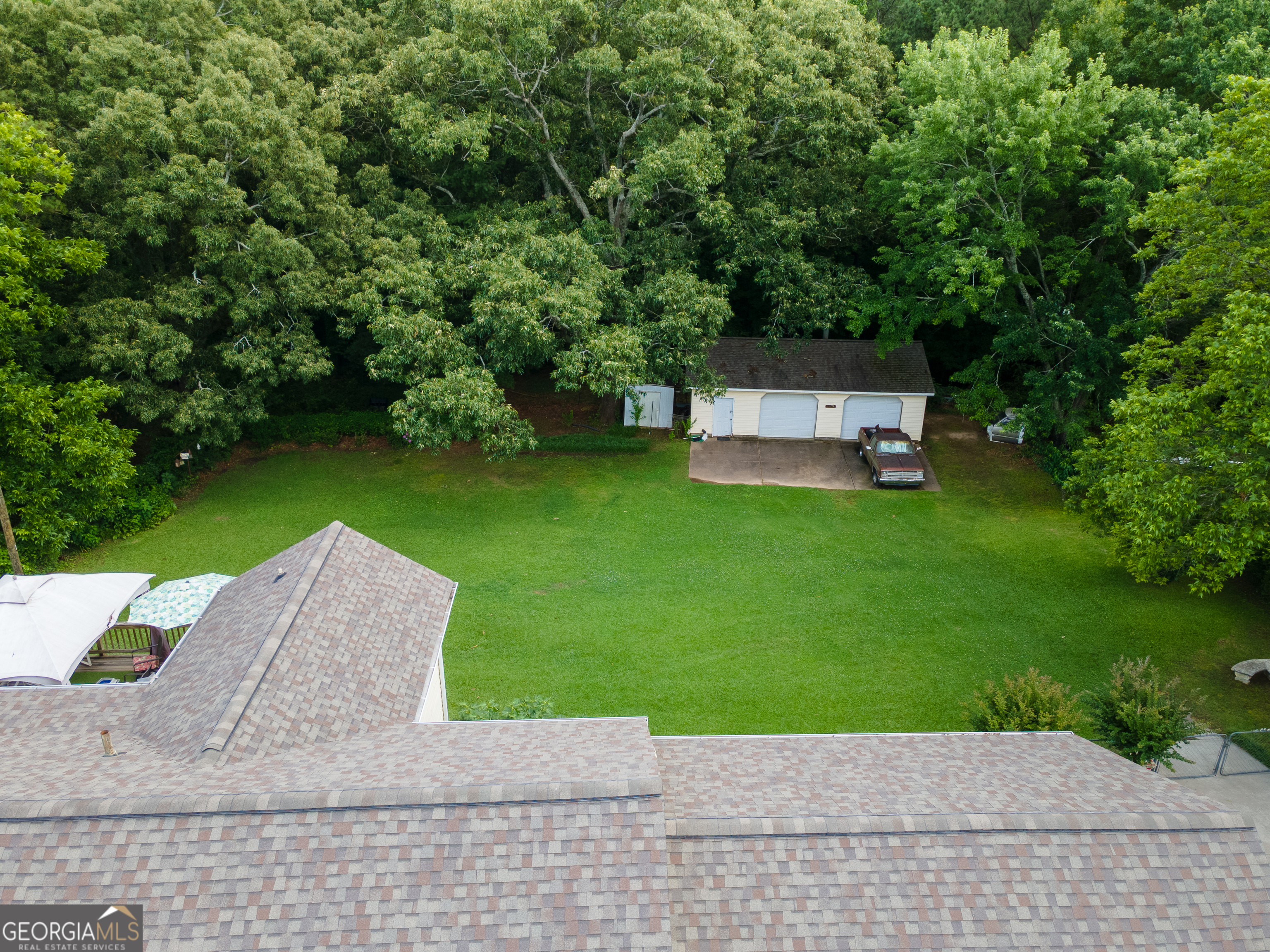4017 South South Bogan Road Buford, GA 30519 - Photo 9 of 11 a view of backyard with a garden and trees