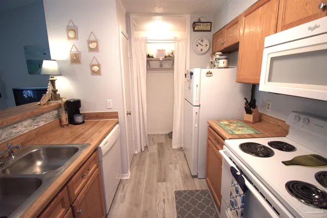 a kitchen with a sink stove and refrigerator