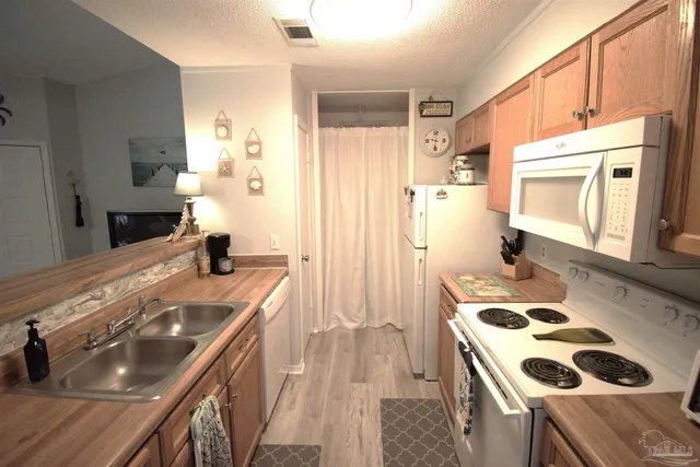 a kitchen with a stove a sink and a refrigerator