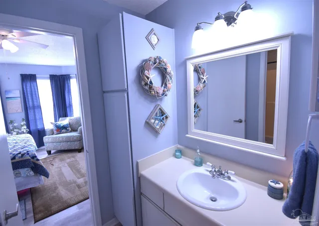 a bathroom with a sink vanity granite tub and a mirror