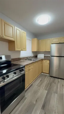 a kitchen with a refrigerator and a stove top oven