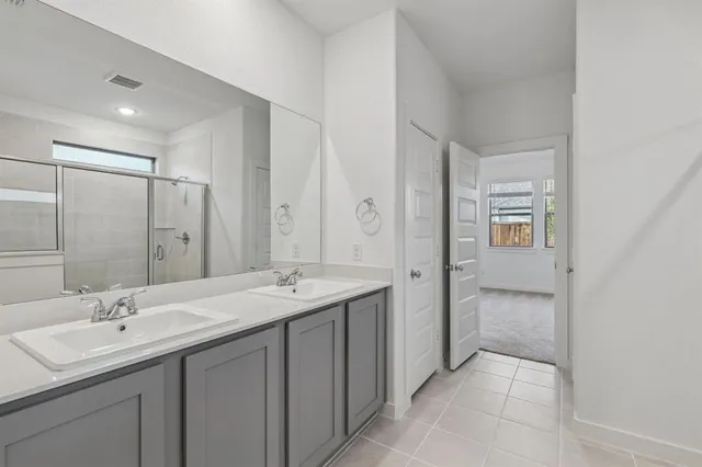a spacious bathroom with a double vanity sink mirror and double