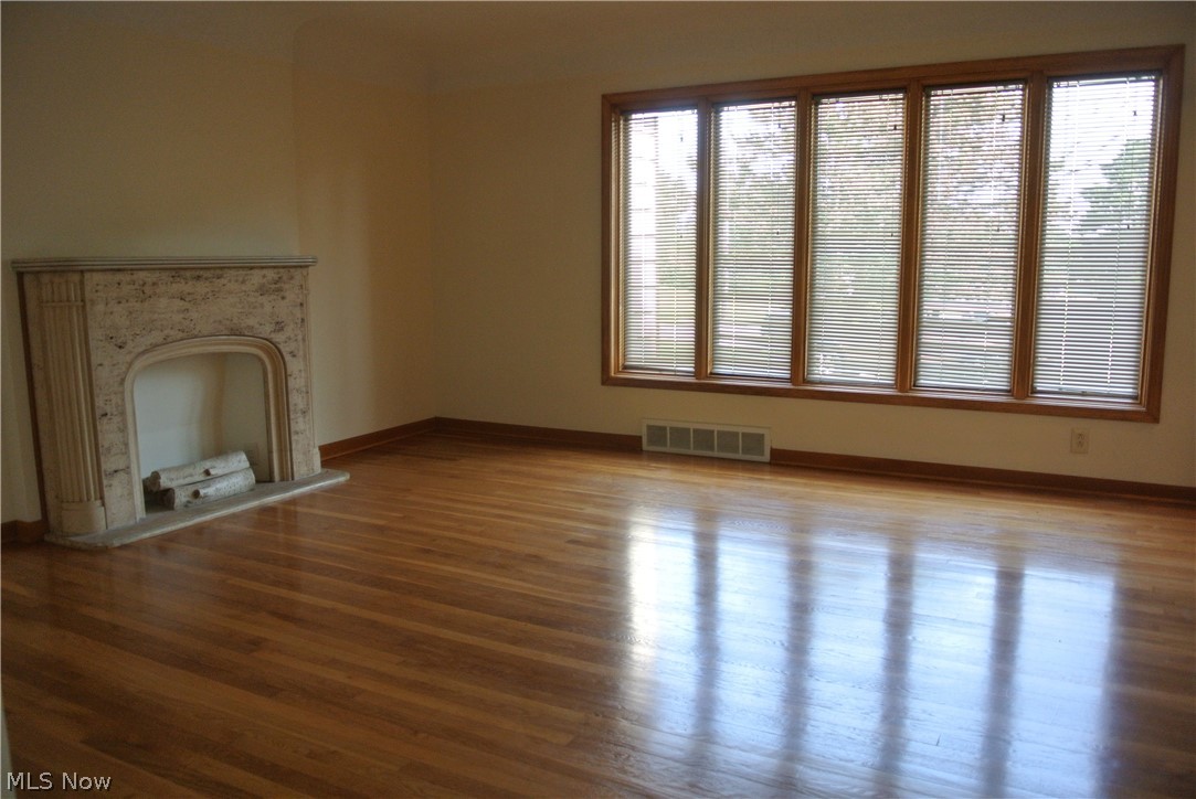 2964 Rockside Road Independence, OH 44131 - Photo 3 of 33 Large living room with wood flooring and decorative fireplace