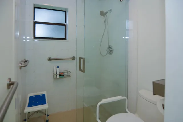 a bathroom with a toilet sink and shower