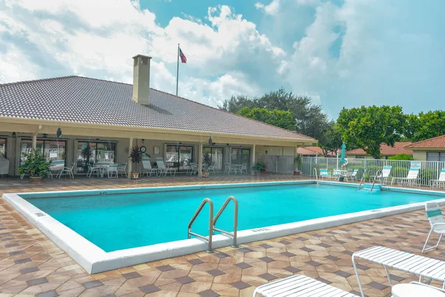 a house view with a swimming pool and garden