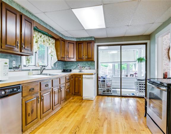 96 Columbia Road Arlington, MA 02474 - Photo 9 of 21 a kitchen with stainless steel appliances wooden floors and wooden cabinets