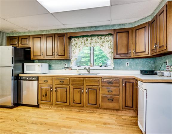 96 Columbia Road Arlington, MA 02474 - Photo 10 of 21 a kitchen with stainless steel appliances granite countertop a stove a sink dishwasher and a refrigerator