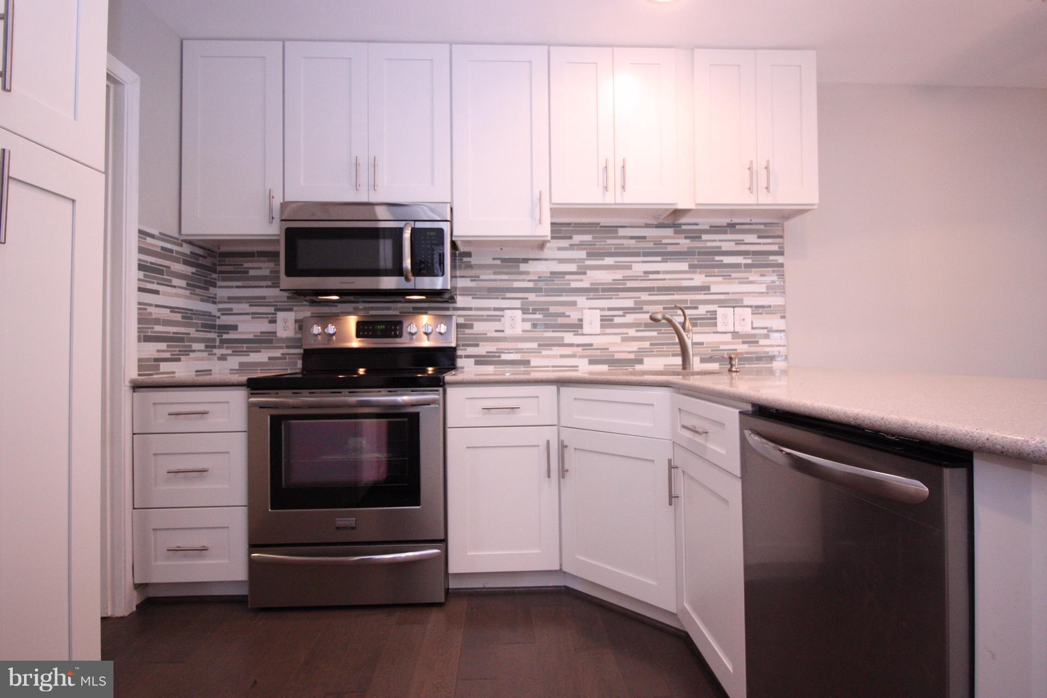 2218 Bear Den Road Frederick, MD 21701 - Photo 2 of 30 a kitchen with stainless steel appliances white cabinets and a stove top oven