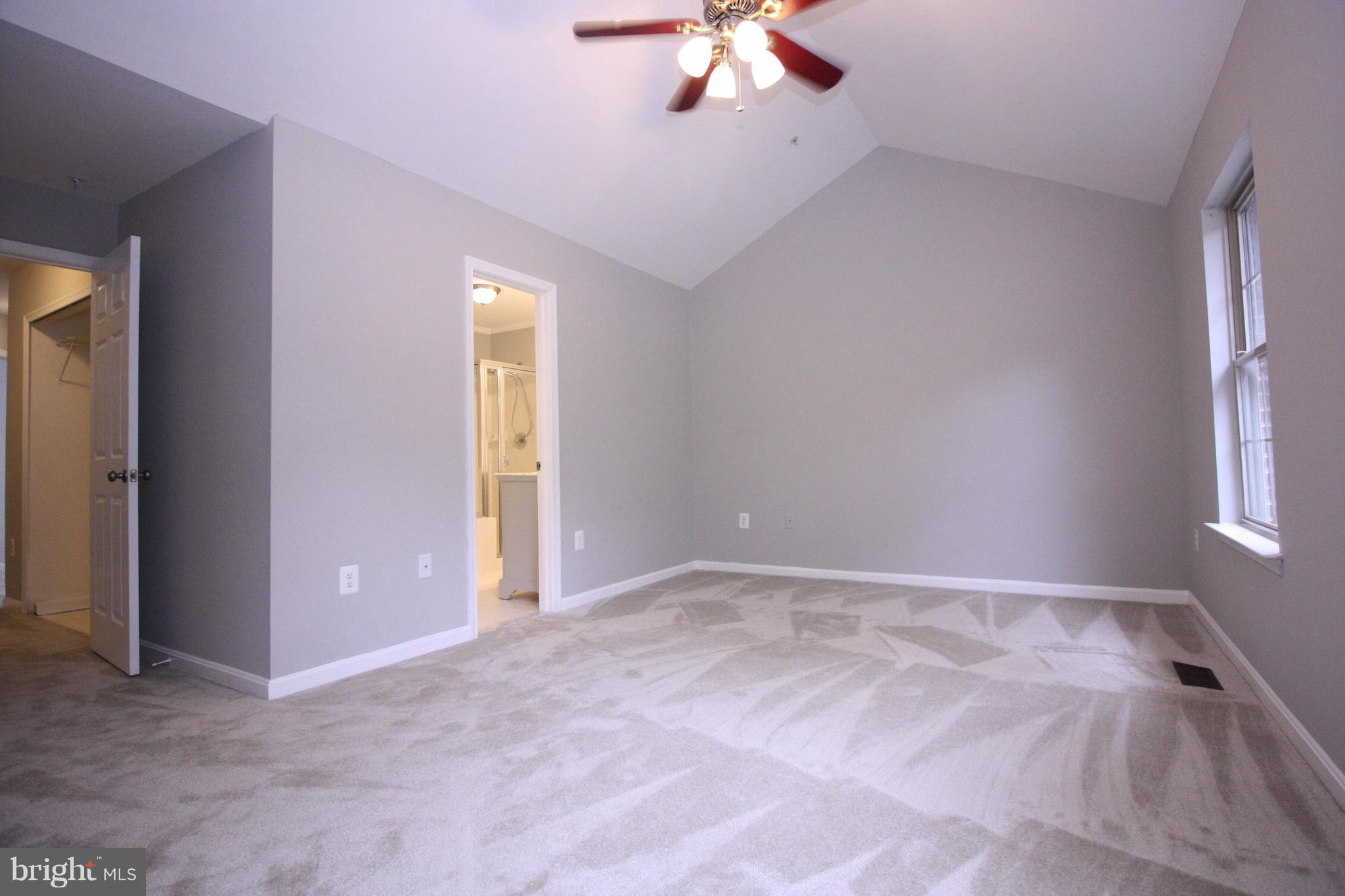 2218 Bear Den Road Frederick, MD 21701 - Photo 14 of 30 an empty room with a chandelier fan and windows