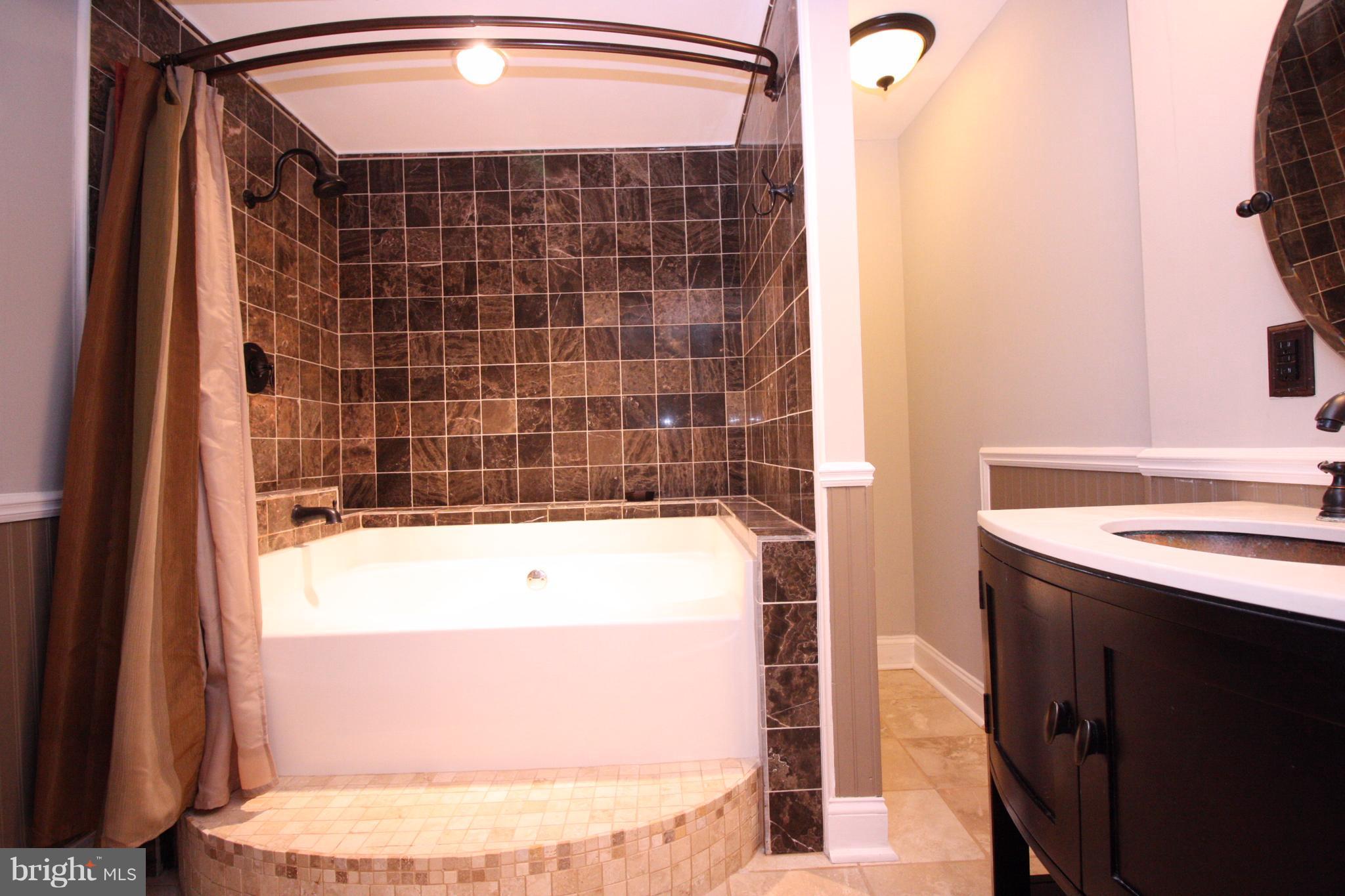 2218 Bear Den Road Frederick, MD 21701 - Photo 23 of 30 a bathroom with a bathtub and a shower