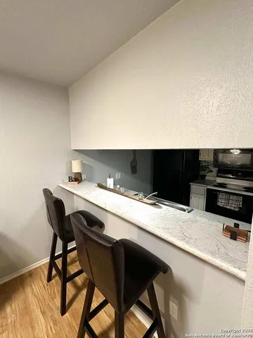 a kitchen with a table chairs and a refrigerator