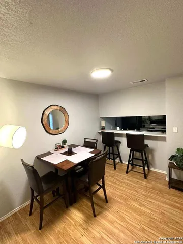 a view of a dining room with a table and chairs