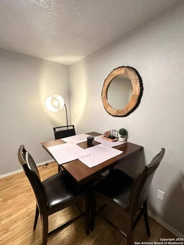 a view of a dining room with a table and chairs