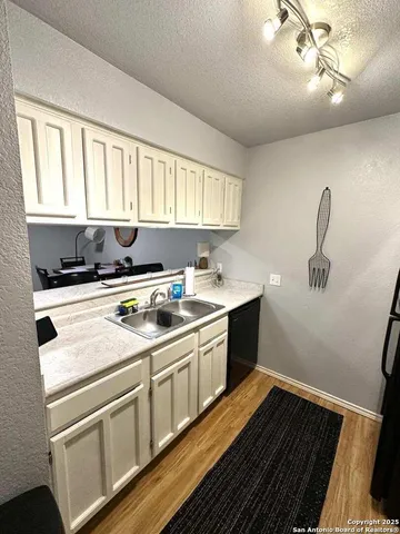 a kitchen with a sink cabinets and window