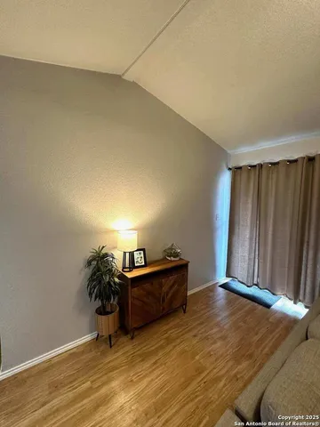 a view of a room with wooden floor