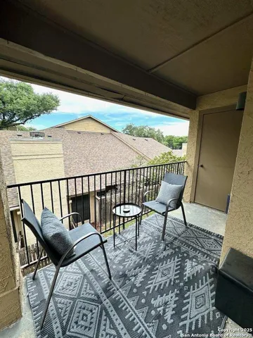 a view of a chairs and table in the balcony