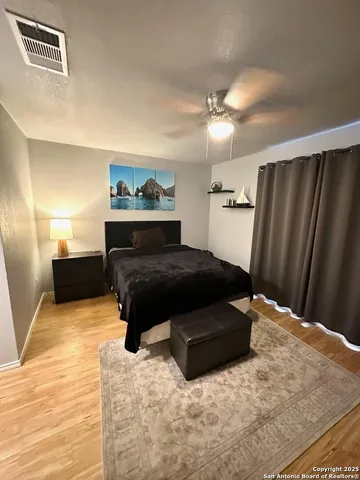 a bedroom with a bed and cabinets