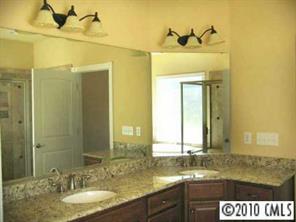 3325 Williams Road Matthews, NC 28105 - Photo 6 of 8 a bathroom with a granite countertop sink and a mirror