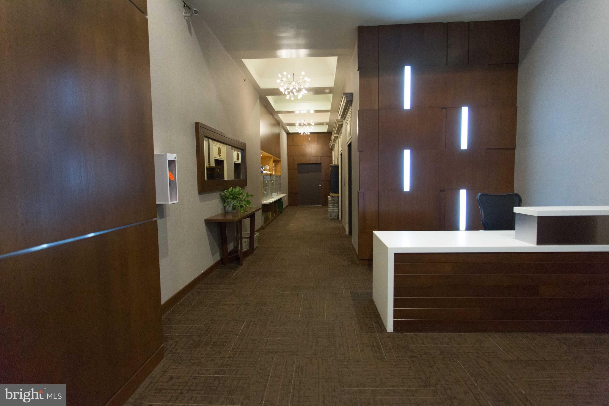 1411-1 Walnut Street, Unit 201 Philadelphia, PA 19102 - Photo 3 of 27 a view of a hallway with seating area