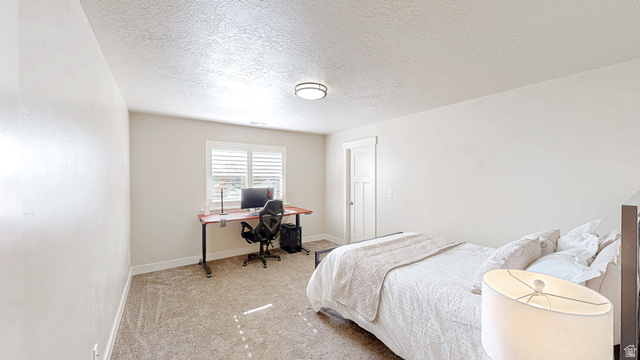 368 East 700 North Springville, UT 84663 - Photo 15 of 55 Bedroom with light colored carpet, a textured ceiling, and a desk