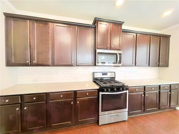 a kitchen with wooden cabinets and a stove top oven