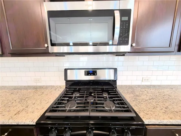 a stove top oven sitting inside of a kitchen