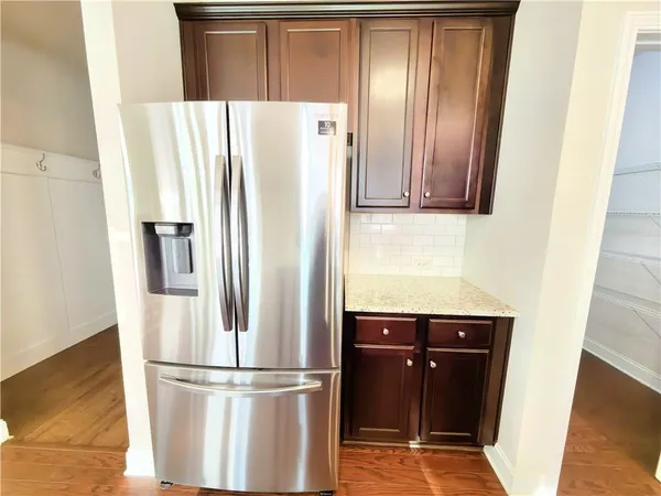 a kitchen with metallic refrigerator freezer and a dishwasher