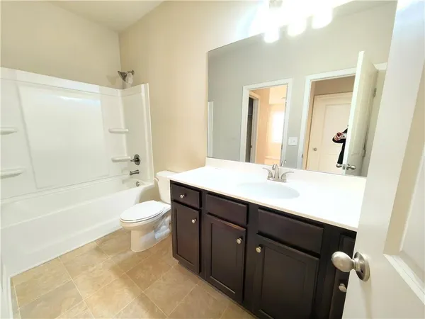 a bathroom with a sink a toilet and bathtub