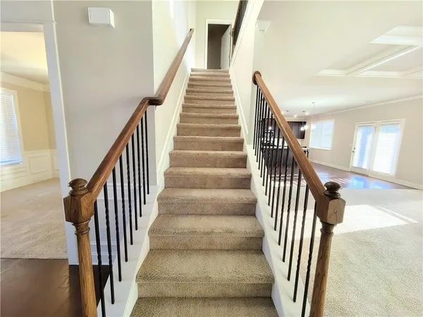 a view of entryway and hall with wooden floor