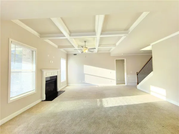 a view of empty room with fireplace and windows
