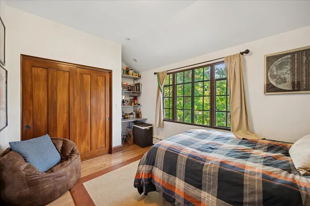 a bedroom with a bed and a window