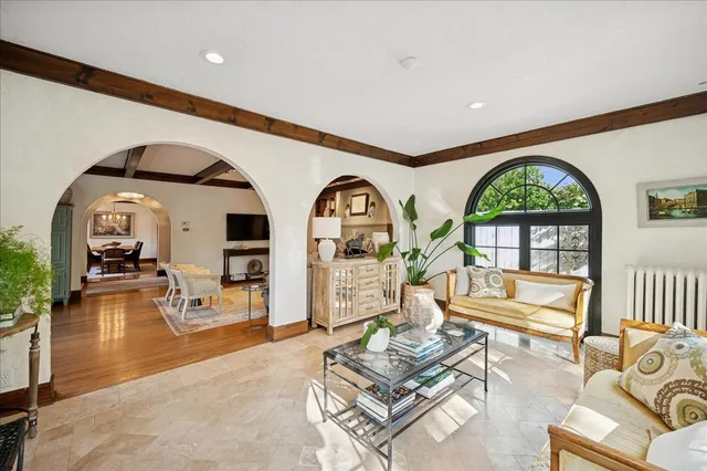 a living room with furniture a rug and wooden floor