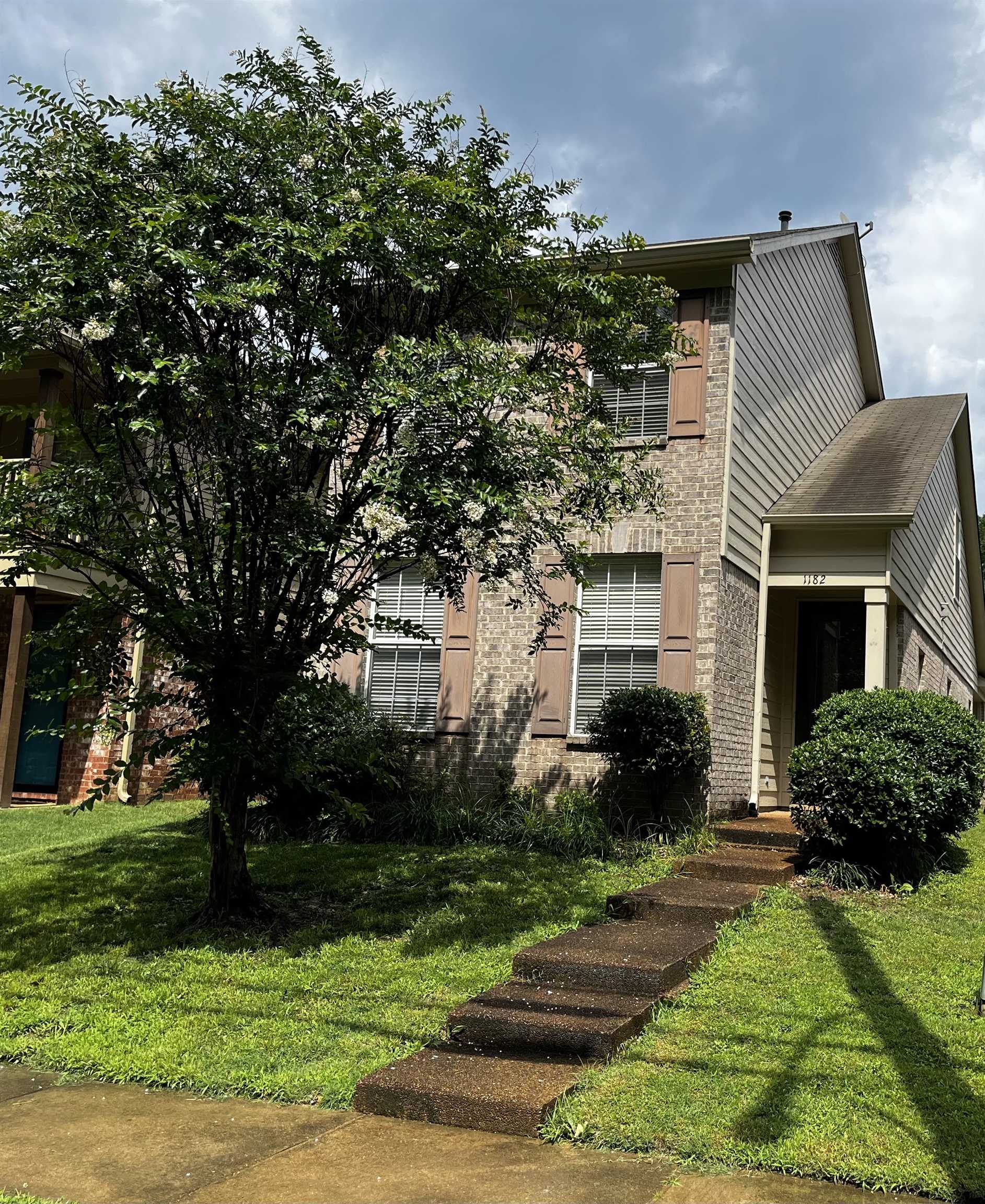 a front view of a house with garden