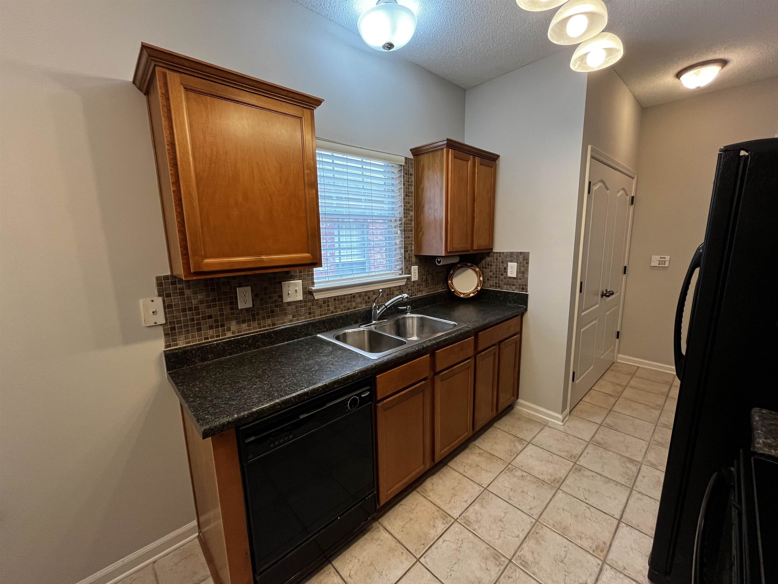 1182 Collierville Arlington Road Collierville, TN 38017 - Photo 14 of 34 a kitchen with stainless steel appliances granite countertop a stove a sink and a microwave