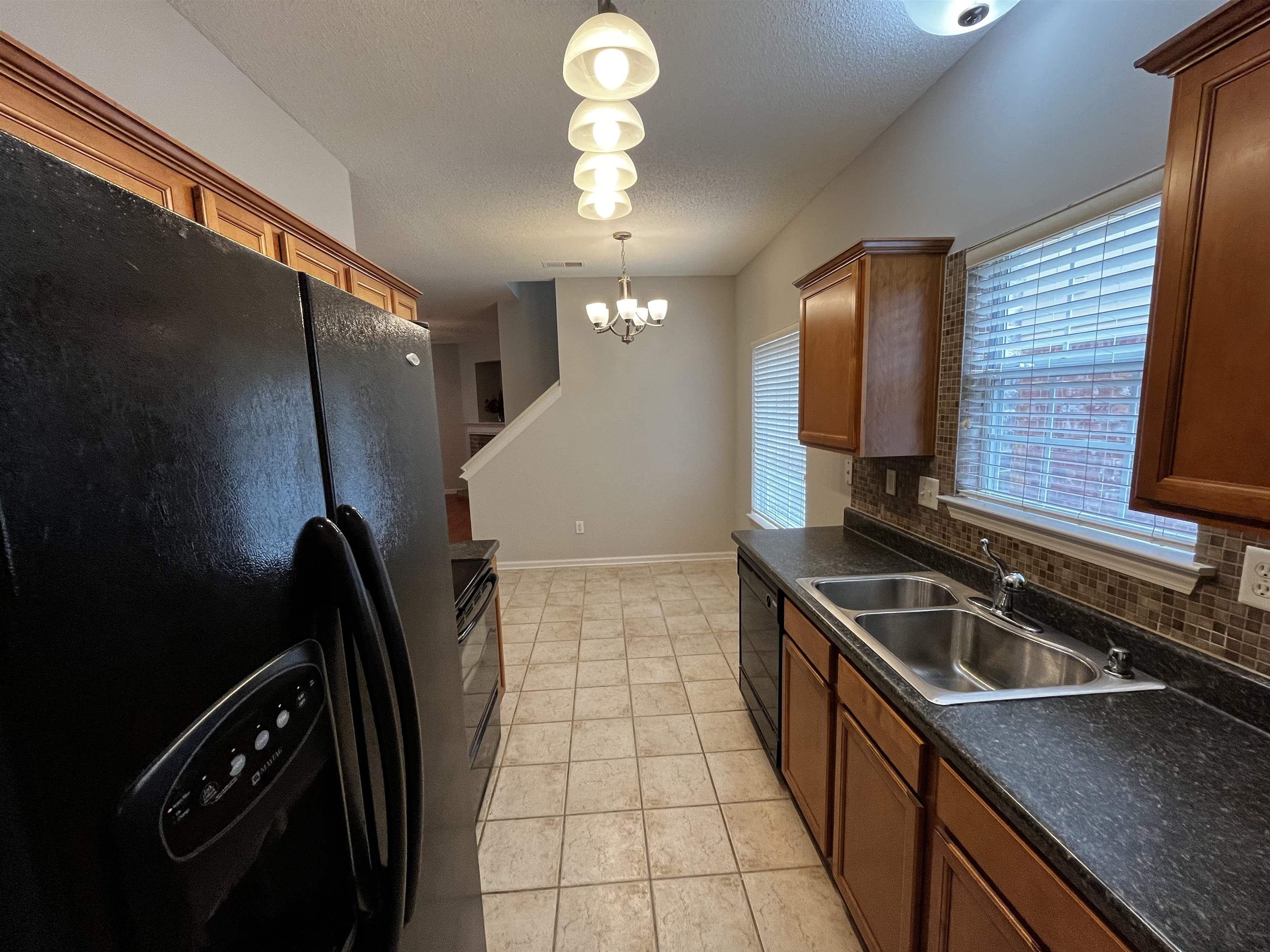 1182 Collierville Arlington Road Collierville, TN 38017 - Photo 15 of 34 a kitchen with a sink a stove and refrigerator