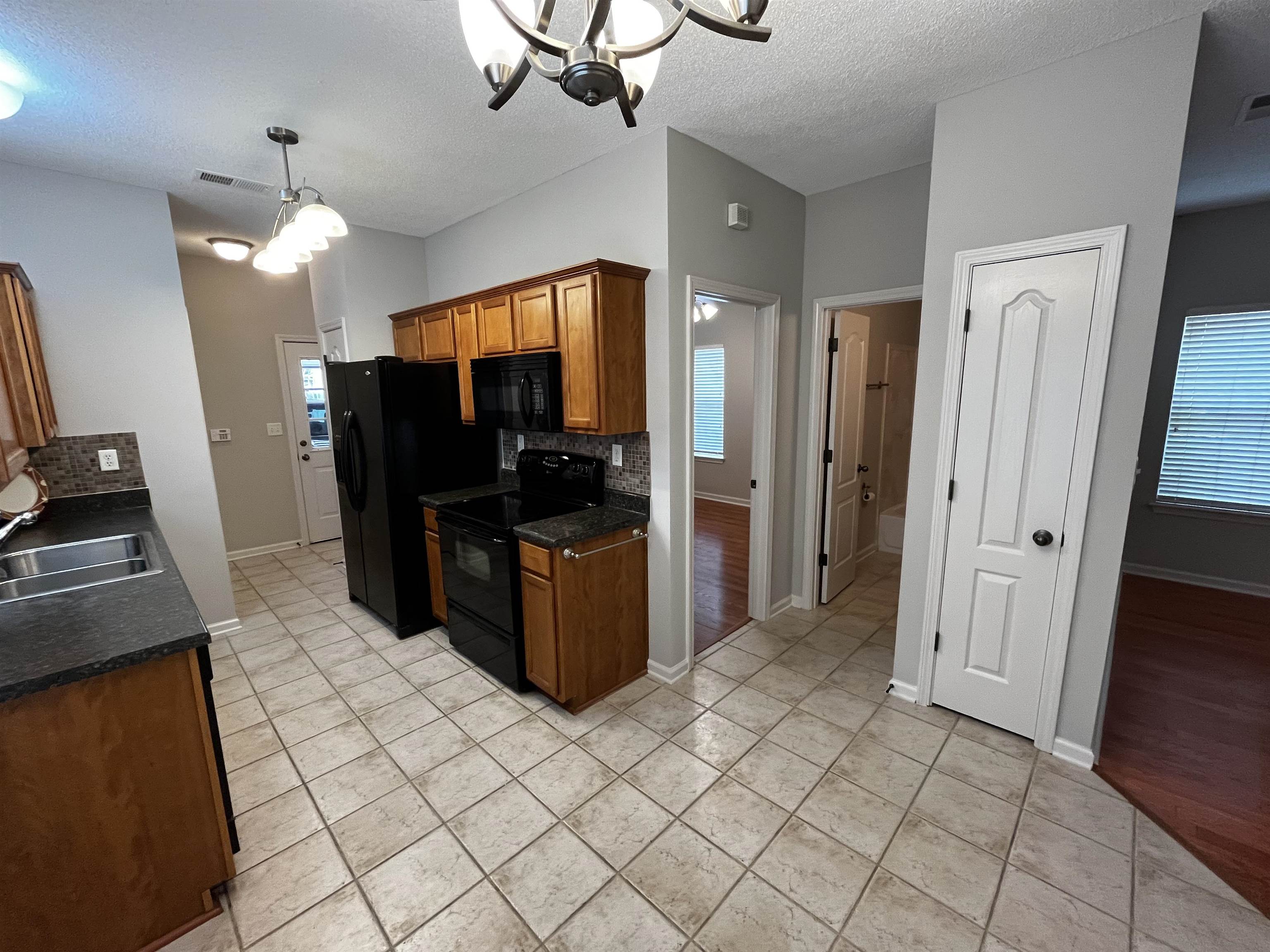 1182 Collierville Arlington Road Collierville, TN 38017 - Photo 16 of 34 a kitchen with stainless steel appliances a refrigerator and microwave