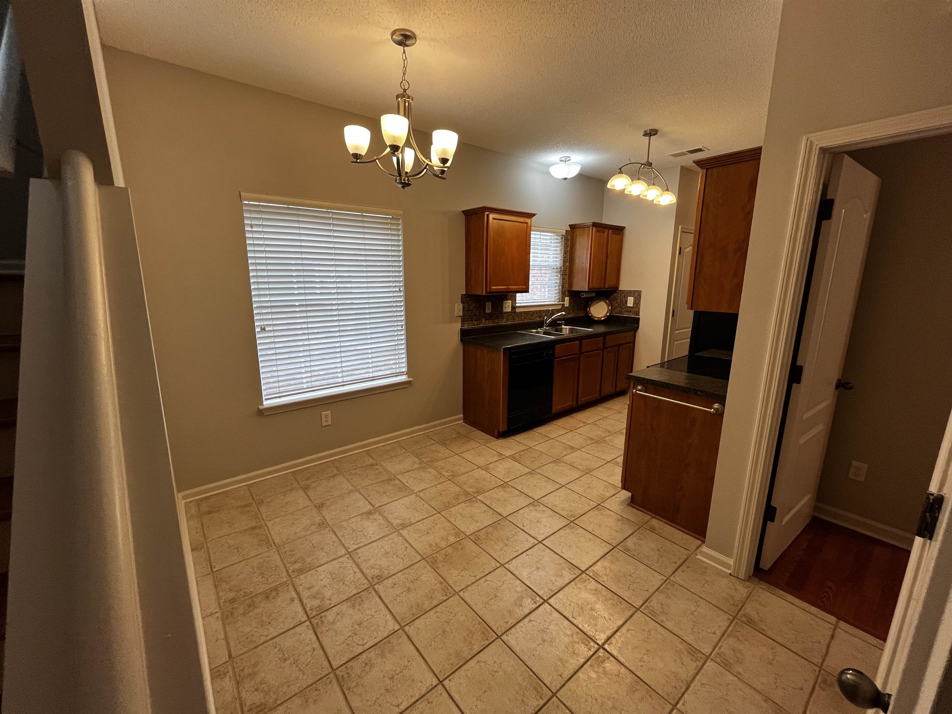 1182 Collierville Arlington Road Collierville, TN 38017 - Photo 17 of 34 a kitchen with stainless steel appliances a refrigerator and a stove