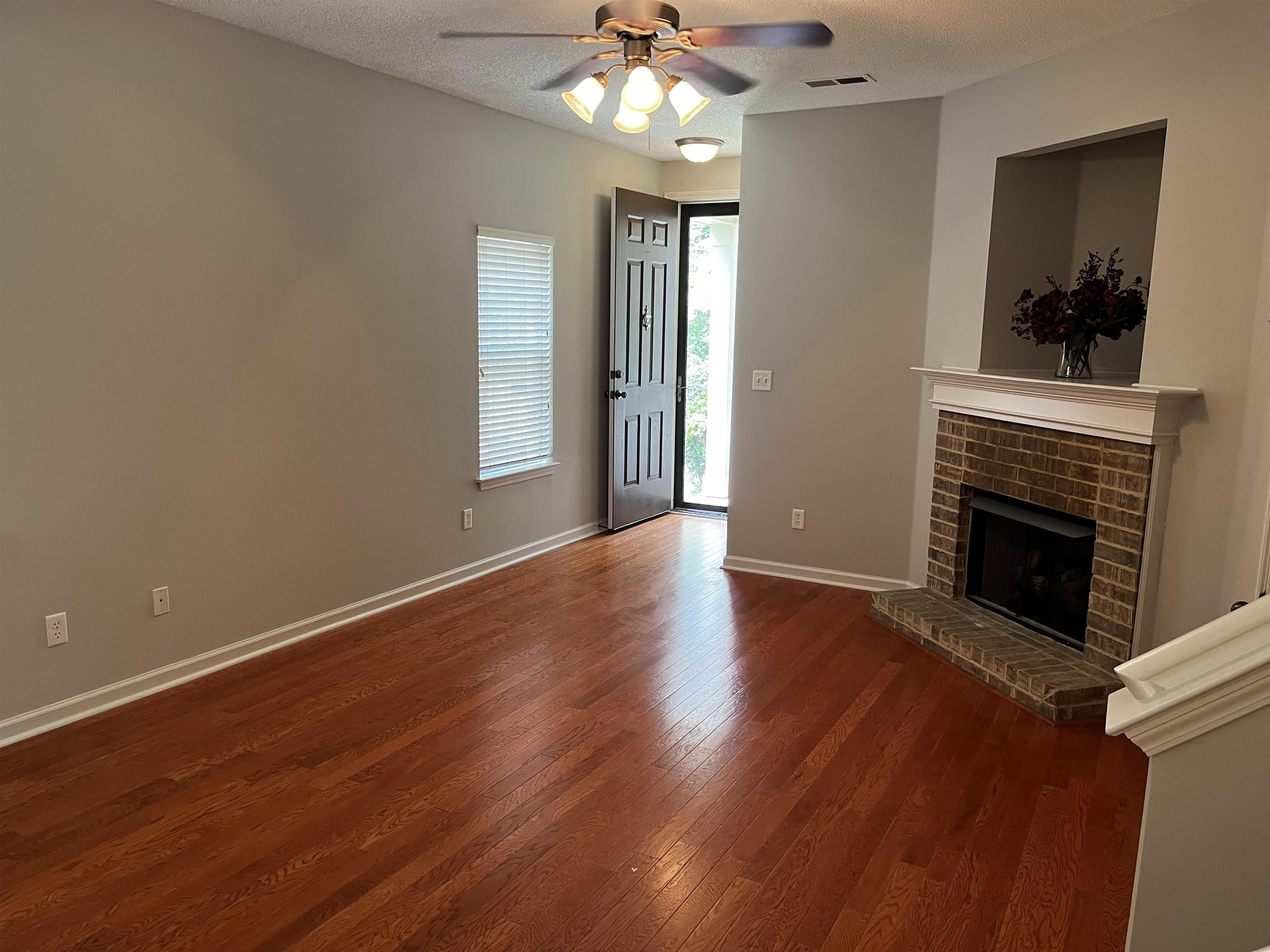 1182 Collierville Arlington Road Collierville, TN 38017 - Photo 2 of 34 wooden floor fireplace and windows in an empty room