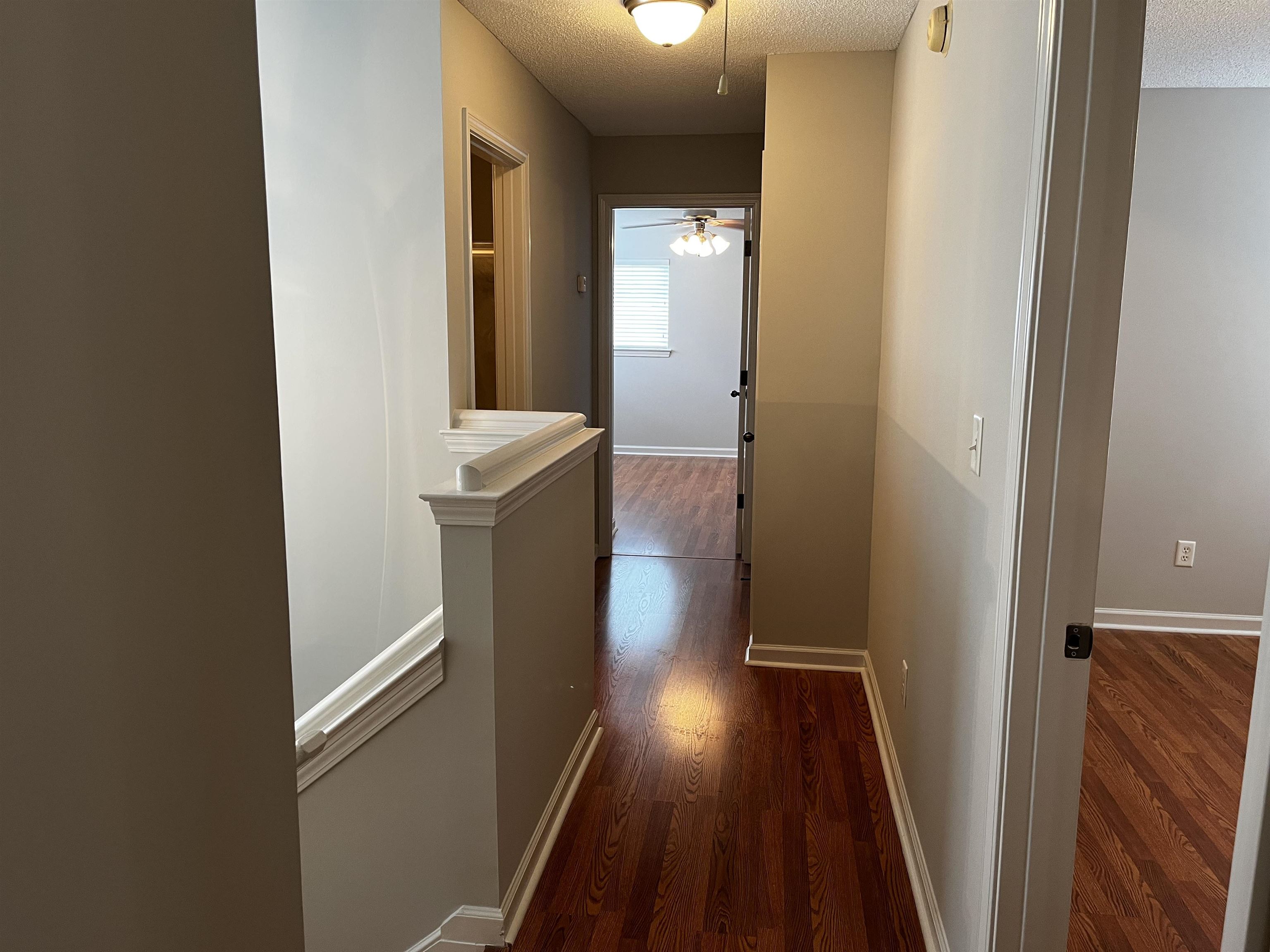 1182 Collierville Arlington Road Collierville, TN 38017 - Photo 21 of 34 a view of a hallway with wooden floor and staircase