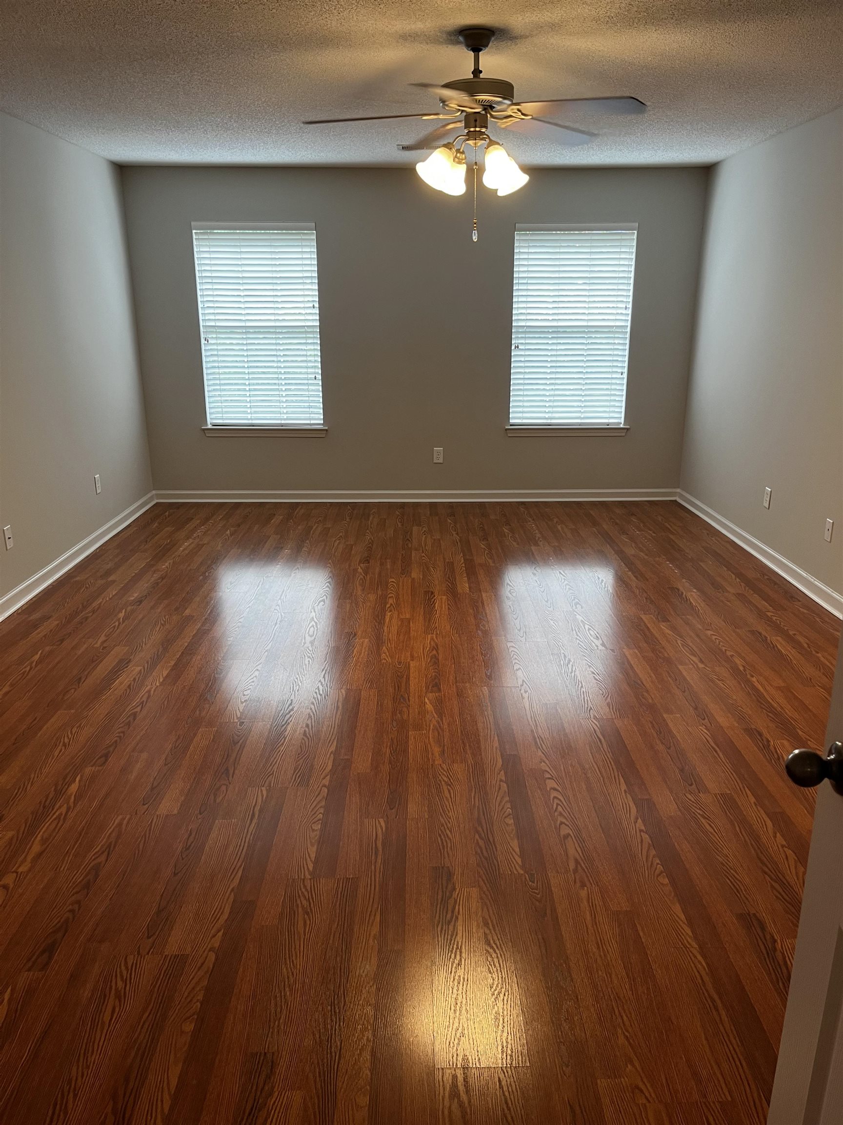 1182 Collierville Arlington Road Collierville, TN 38017 - Photo 4 of 34 a view of an empty room with wooden floor and a window