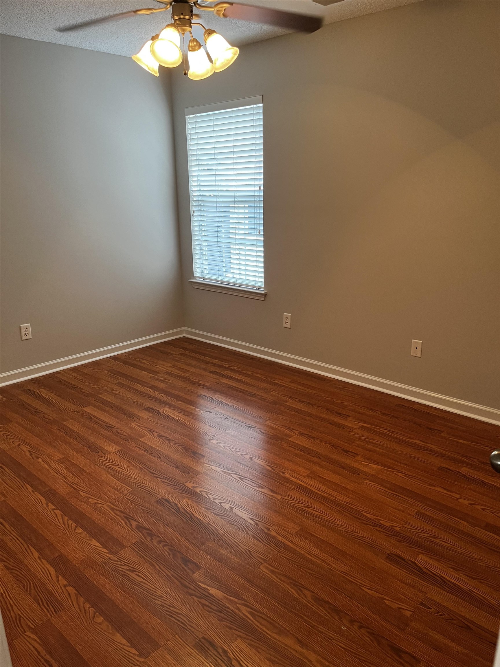 1182 Collierville Arlington Road Collierville, TN 38017 - Photo 5 of 34 an empty room with wooden floor and windows