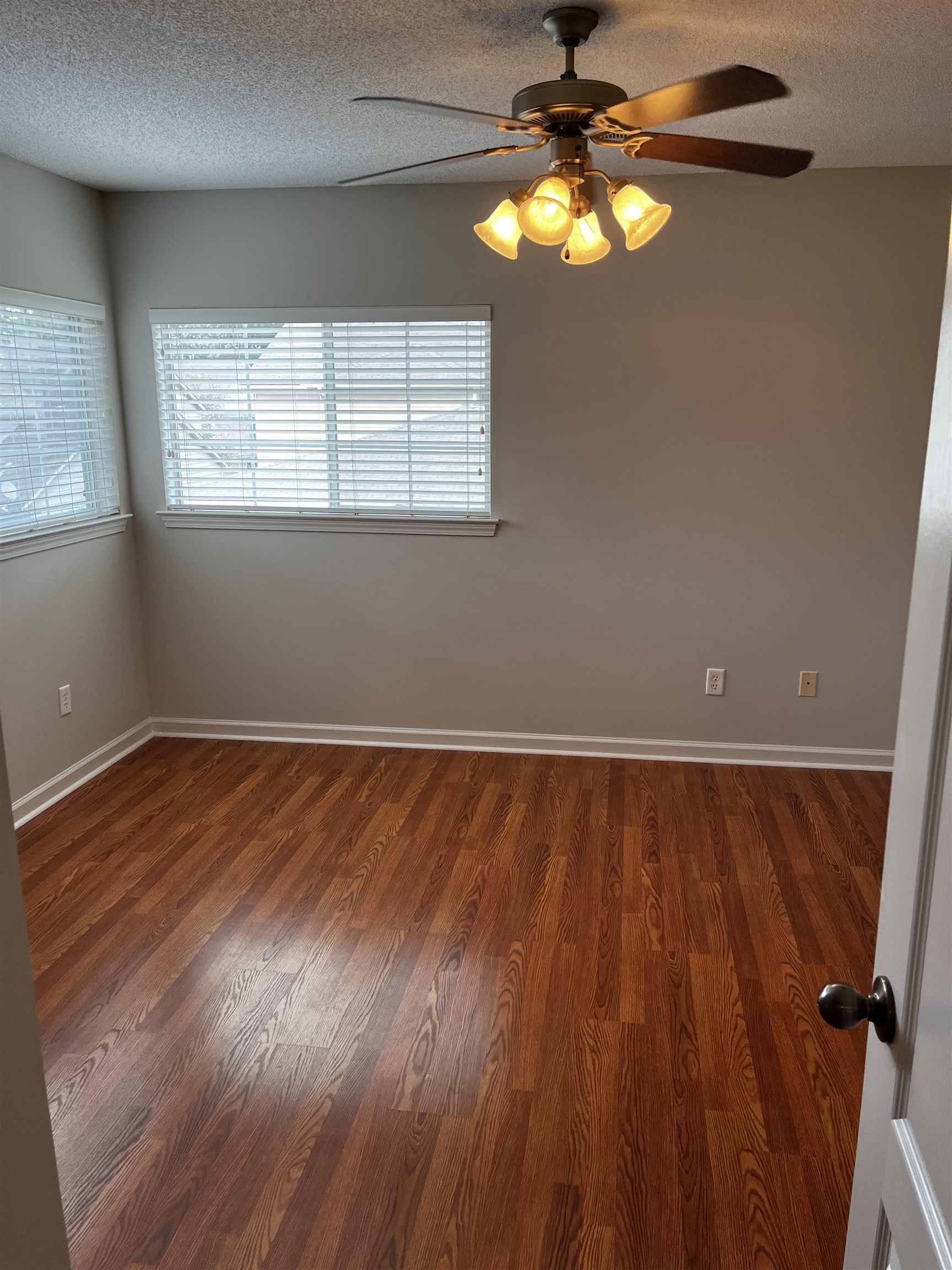 1182 Collierville Arlington Road Collierville, TN 38017 - Photo 6 of 34 a view of an empty room with wooden floor and a window