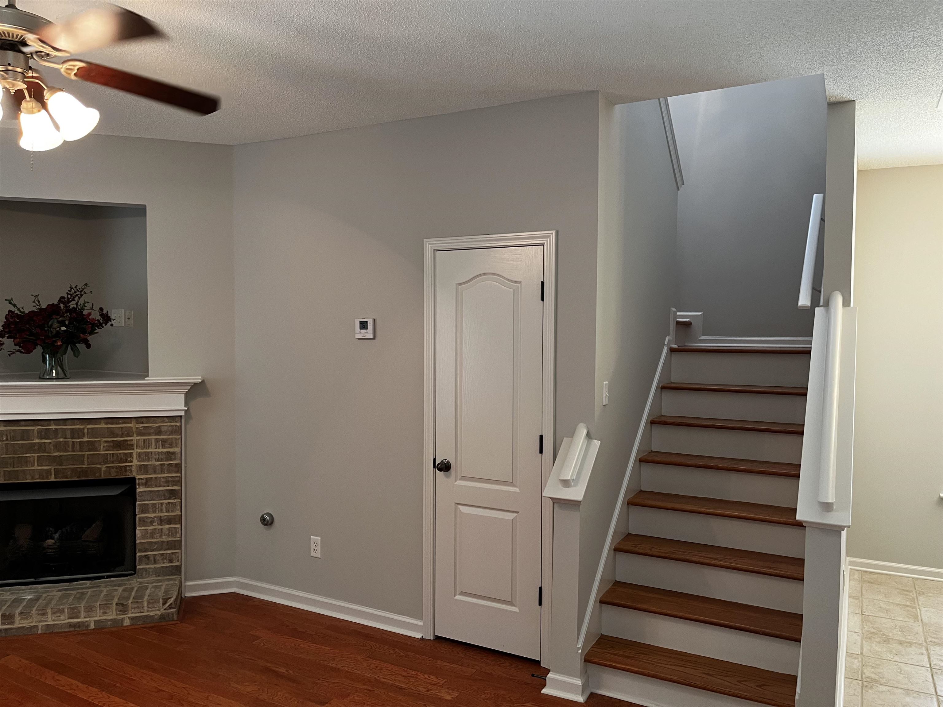 1182 Collierville Arlington Road Collierville, TN 38017 - Photo 9 of 34 a view of a livingroom with wooden floor and a fireplace