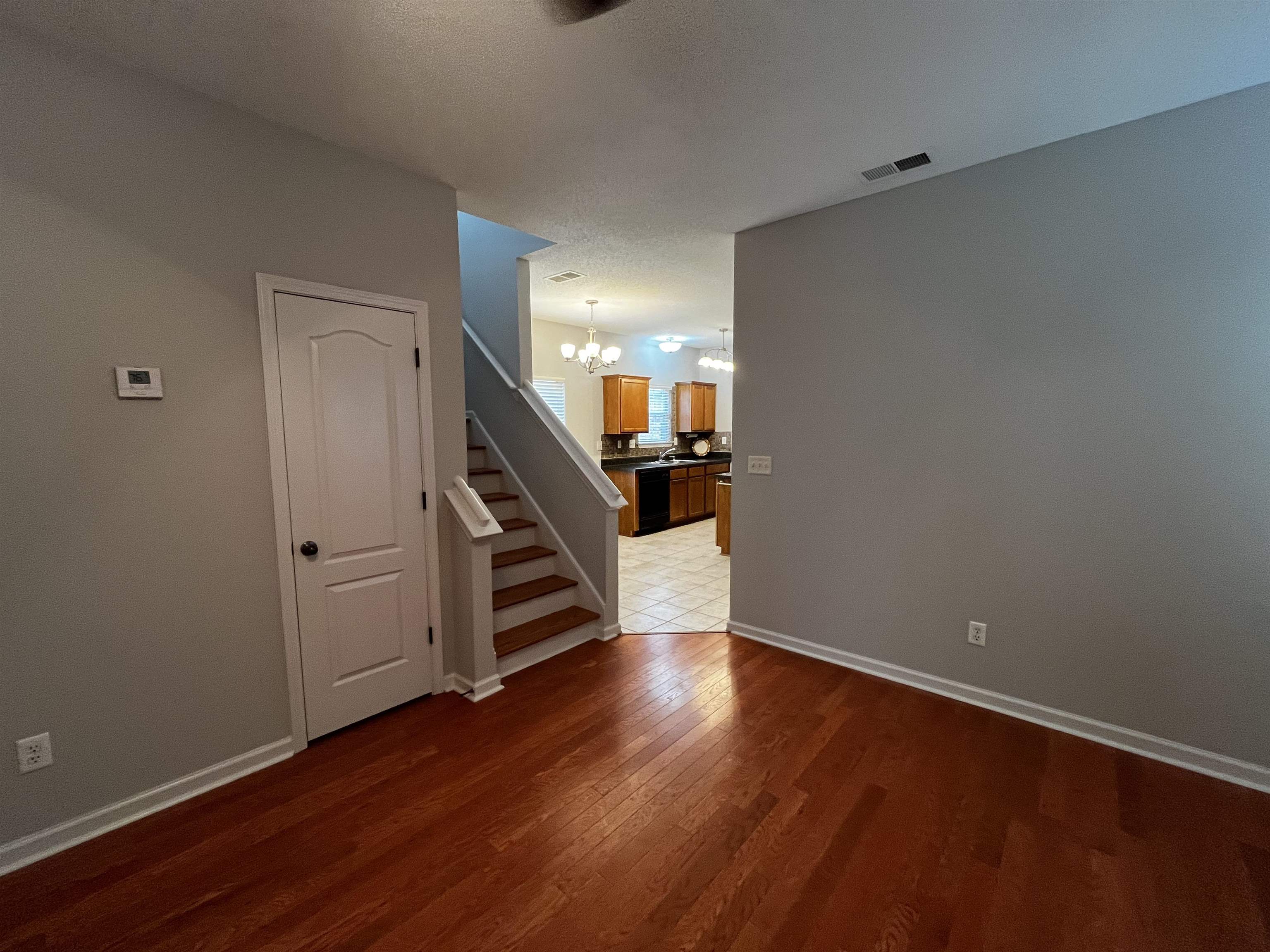 1182 Collierville Arlington Road Collierville, TN 38017 - Photo 10 of 34 a view of a hallway with wooden floor and stairs